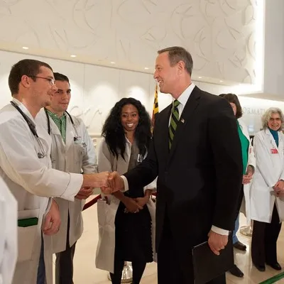 A group of doctors shaking hands in a hospital, symbolizing collaboration and teamwork in healthcare.