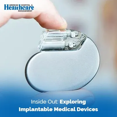 A person holding a medical device in their hand, examining it closely