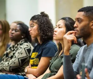 a group of people sitting next to each other